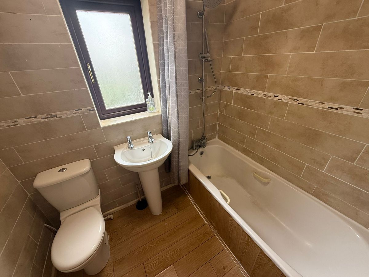 Bathroom before the end of tenancy clean, with residue in the bath