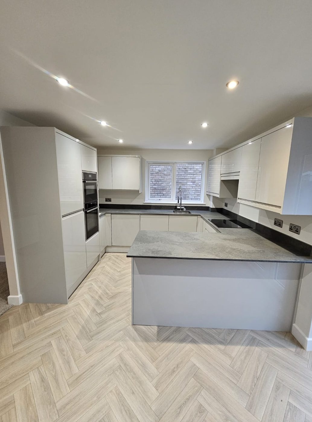 Post-construction clean of a new gloss kitchen with herringbone floor