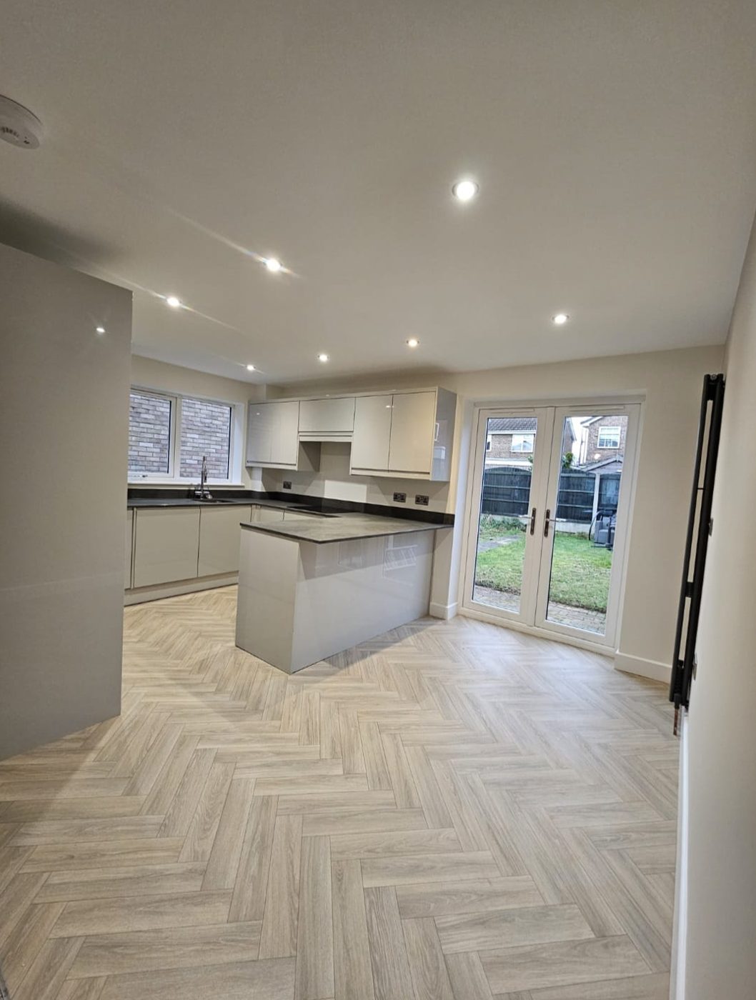 Post-construction clean of an open-plan kitchen diner with garden doors